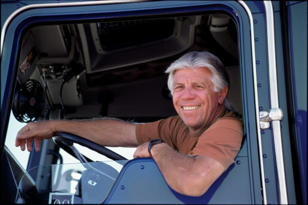 A portrait of a friendly caucasian male truck driver.