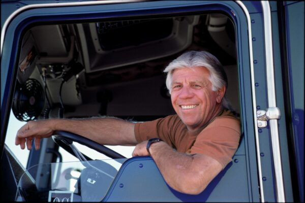 A portrait of a friendly caucasian male truck driver.